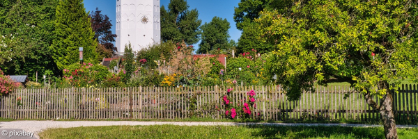 Bloick auf den Bibelgarten mit Kirchturm im Hintergrund
